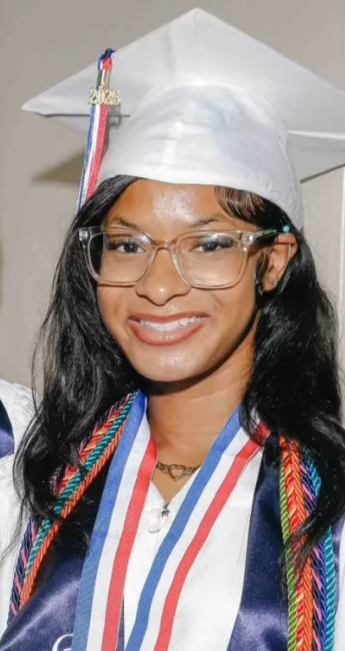 Graduate in white cap and gown