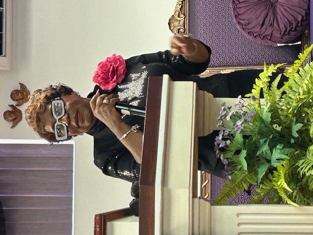 Woman in black with pink flower